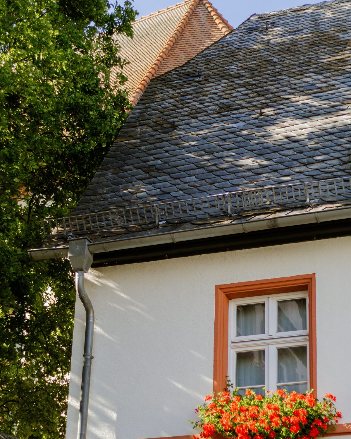 A house with a worn and mossy roof