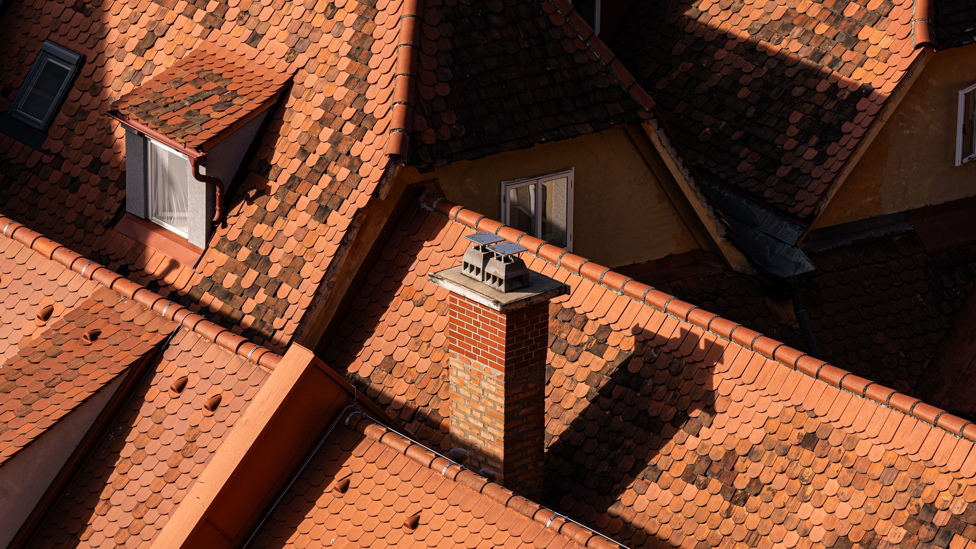 Orange tile roofs and chimneys seen from above